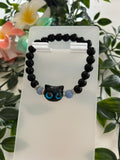 Bracelet Cristal Noir – Charm Chat Yeux Bleus