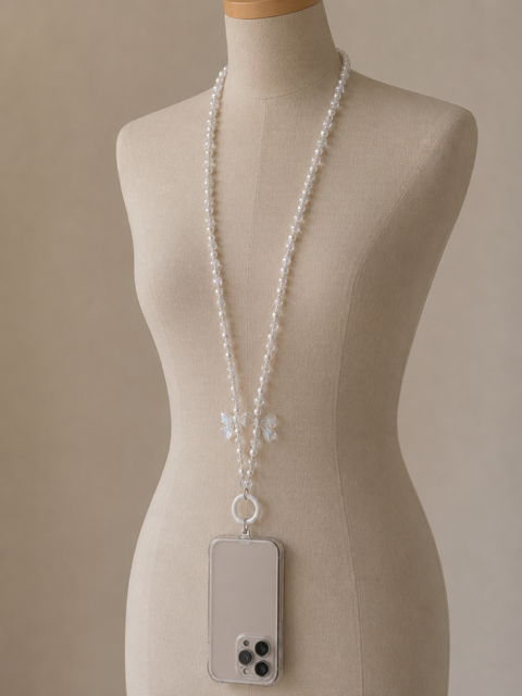 Long cordon téléphone grandes perles blanches acryliques et papillon cristal transparent